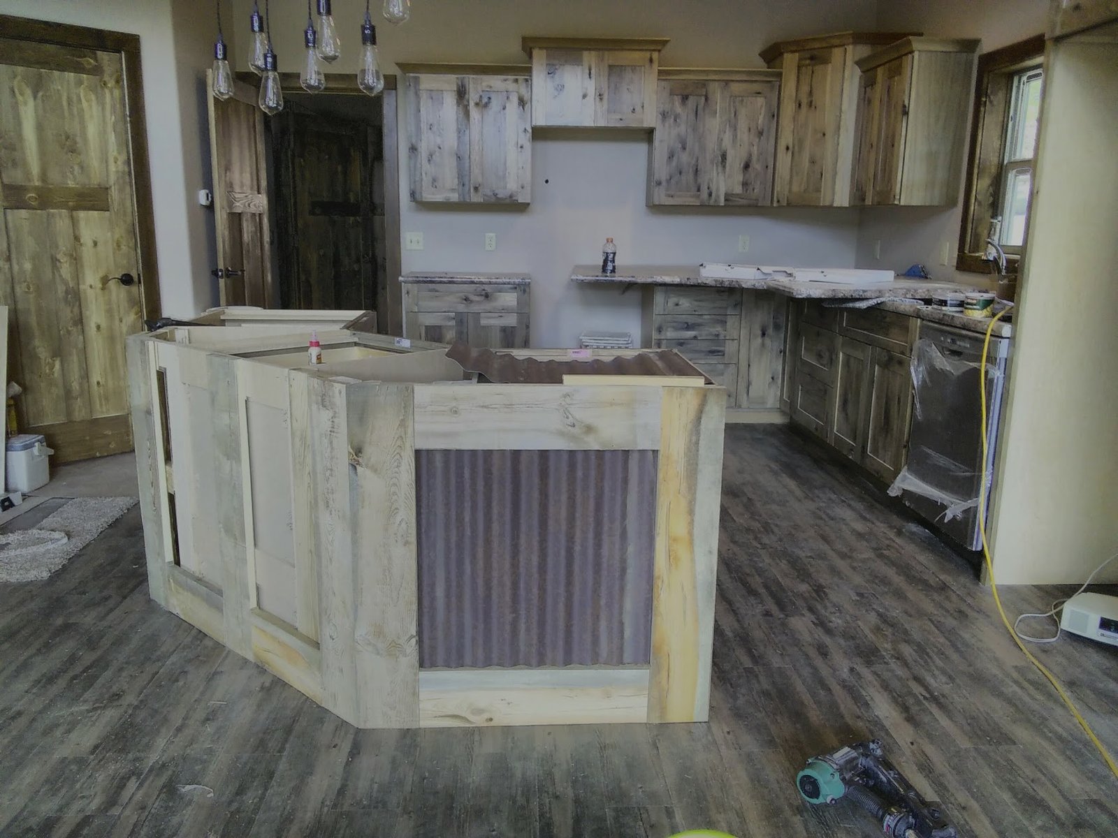 Brookfield kitchen remodel with rustic cabinets and corrugated-metal island.