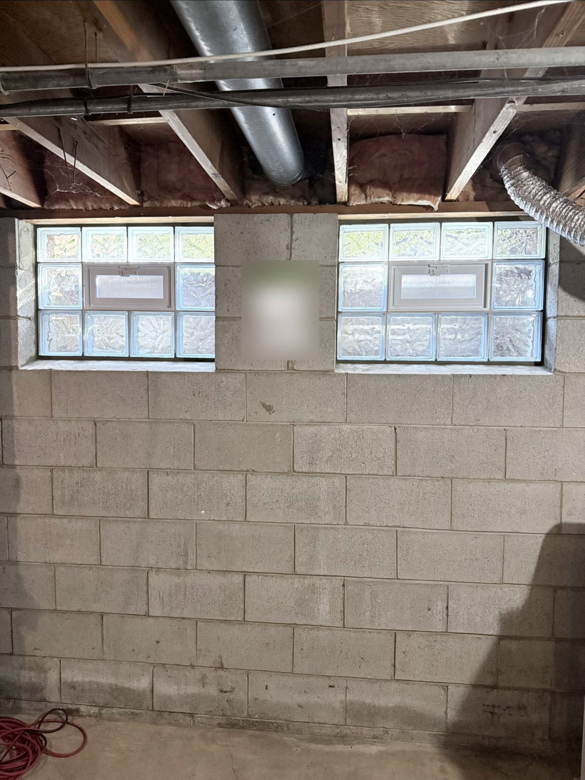 Finished vented glass block basement windows set in a block foundation wall, interior view.