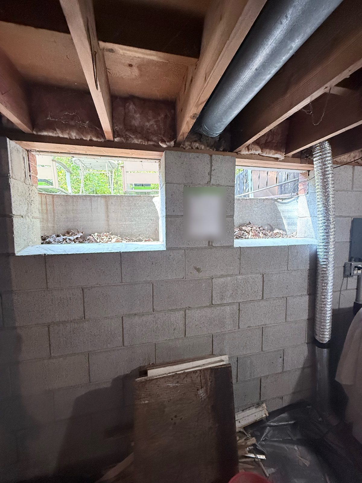 Basement window openings cleared out and ready for new glass block, interior view.