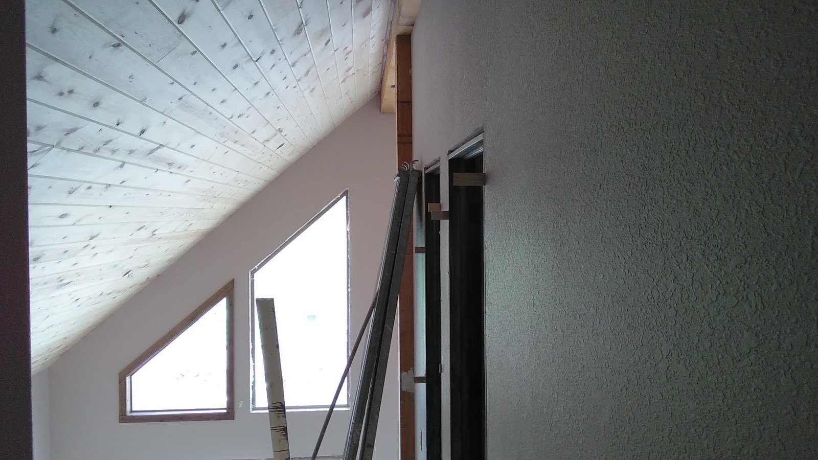 Brookfield remodel — vaulted wood-plank ceiling and angled window wall.