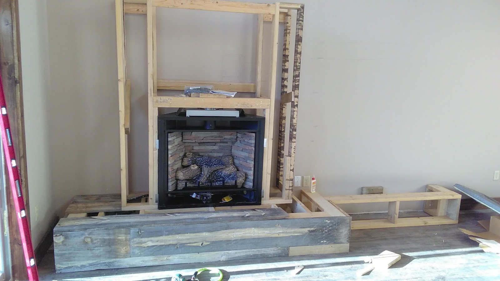 Brookfield fireplace framing and rustic wood hearth under construction.