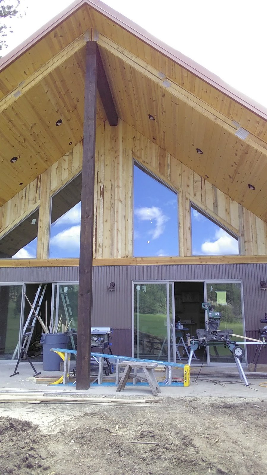 Brookfield A-frame exterior with wood and corrugated metal during remodel.